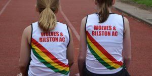 Two girls wearing club vests