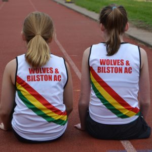 Two girls wearing club vests